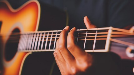 Fototapeta premium a person playing the acoustic guitar, focusing on the hands and fretboard