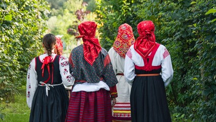 Women in Traditional Attire Walking in Nature