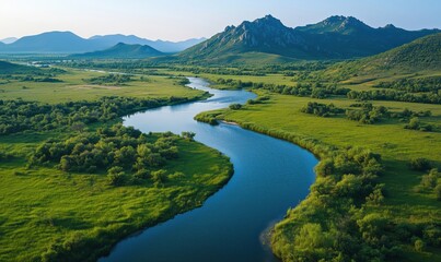 Scenic river winding through lush green landscape with mountains in background