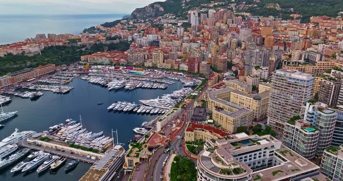 Birds eye aerial view of traffic in Monte Carlo, Monaco. Famous formula one Grand Prix Circuit. Aerial view of the city of Monaco. Establishing shot showcases luxury yachts moored in Monaco bay