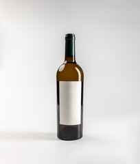 Mockup of amber bottle of white garnacha wine, on white background with copyspace, 750 ml, real photo