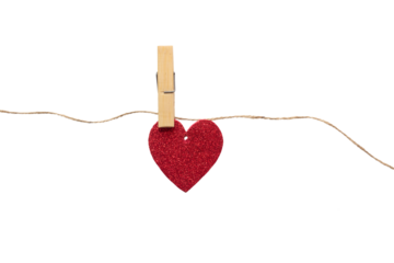 Paper heart with glitter hanging on a rope with a clothespin. Heart isolated on white background