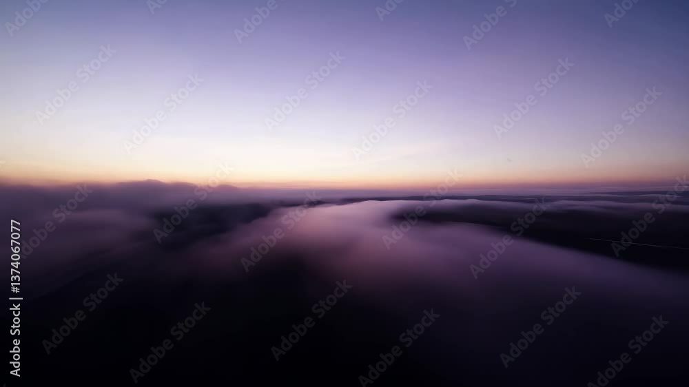 Aufkleber a blurry image of a cloudy sky with a purple hue. the sky is filled with clouds and the sun is setti