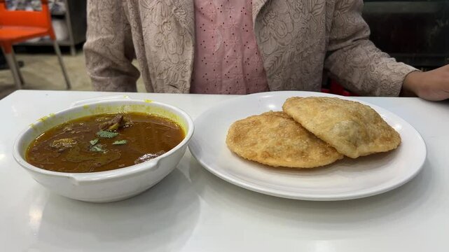 Close up shot of dal puri and mutton nihari served in a restaurant in Kolkata.