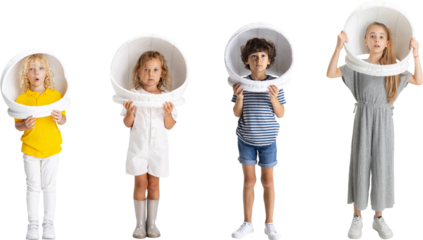Dreamy childhood. Collage. Four playful joyful children, kids, boys and girl in astronaut helmets posing against transparent background. Concept of family, child, motherhood, youth.