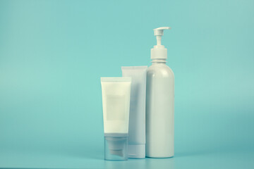 Empty tubes of cream on a blue background. Complex of creams for skin care.