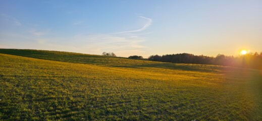 Golden fields stretching under a sunset sky, showcasing the beauty of rural landscapes and evoking...