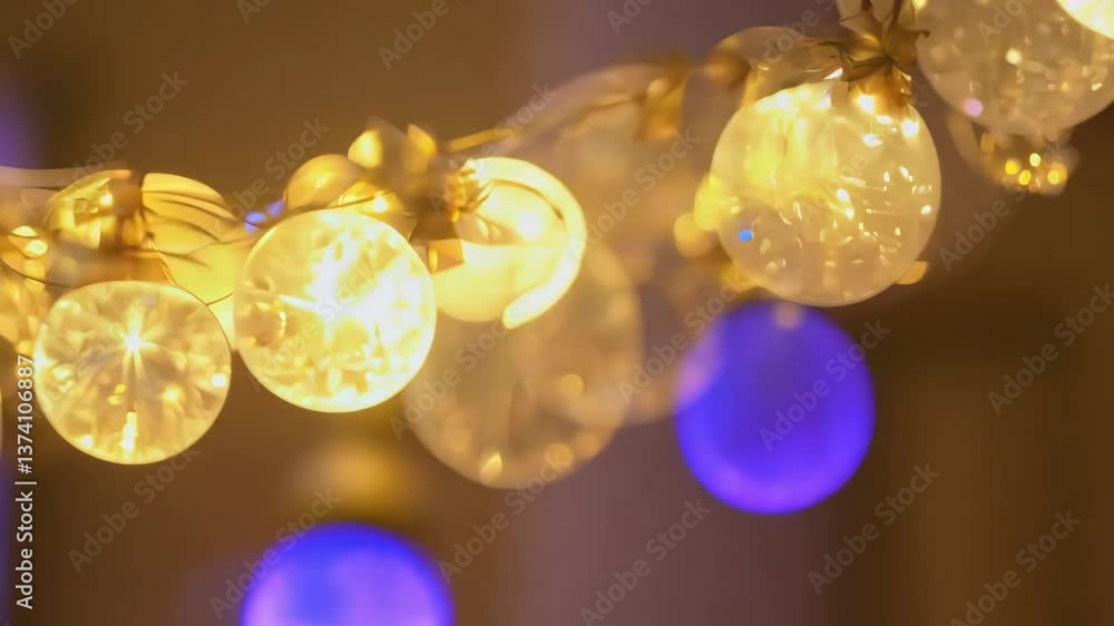 Poster a string of lights with many small lights on it. the lights are yellow and are hanging from the ceil