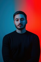 Obraz premium Portrait of young man with blue and red lighting, close-up
