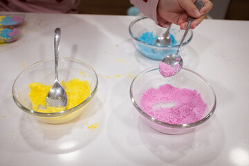Preparing colorful soap toys with some powder and colour salts in pots