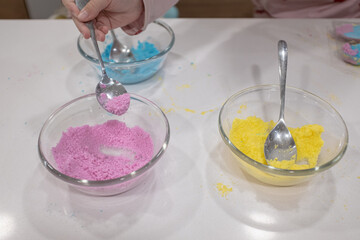 Preparing colorful soap toys with some powder and colour salts in pots
