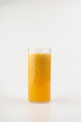 Glass of fresh tangerine juice and fruits