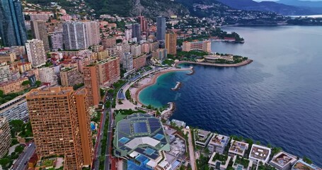 Birds eye aerial view of traffic in Monte Carlo, Monaco. Famous formula one Grand Prix Circuit. Aerial view of the city of Monaco. Establishing shot showcases luxury yachts moored in Monaco bay
