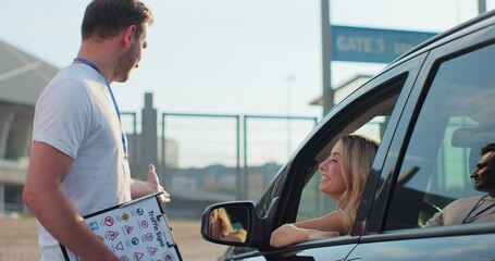 Instructor giving a five to a woman driver sitting in the car while learning to drive on the training ground. Driver courses, exam and people concept.
