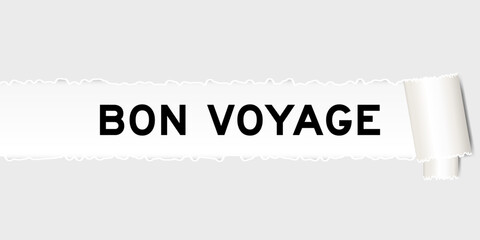 Ripped gray paper background that have word bon voyage under torn part