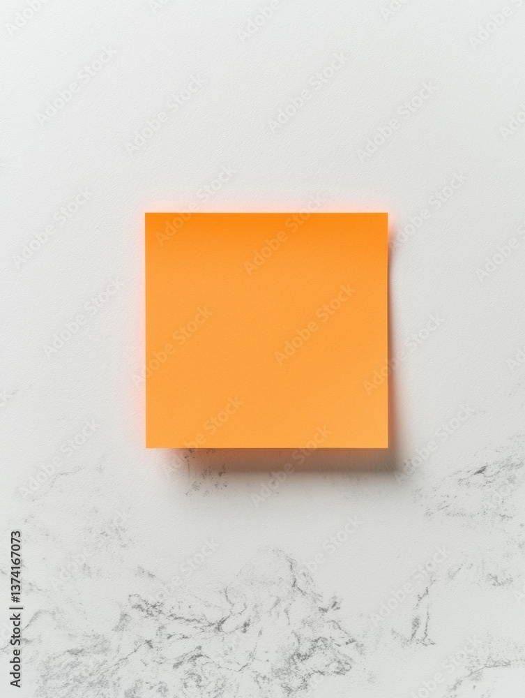 Poster square-shaped orange square on a white marble surface. the square is in the center of the image and 