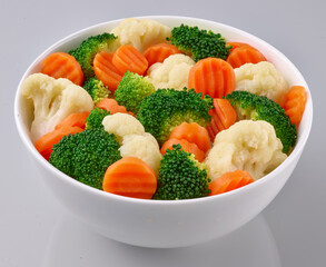 Rahmgemuese in weisser Porzellanschale, Möhren, Gemüse, isoliert, Brokkoli