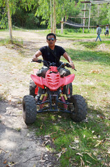 Travelers young thai men biking and riding ATV motorcycle auto or All Terrain Vehicle or quad bike...
