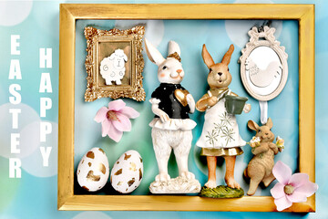 Easter flat lay background with bunny figurines and decors inside golden frame