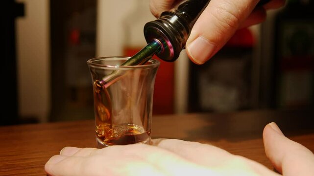 Bartender amator prepares b52 cocktail with minimal equipment