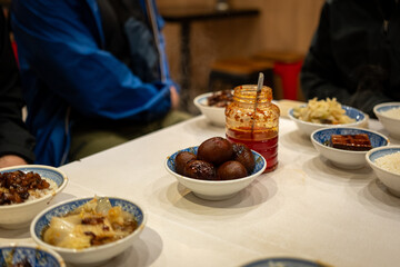 A spread of Taiwanese appetizers like braised peanuts and marinated tofu are ready to be shared.