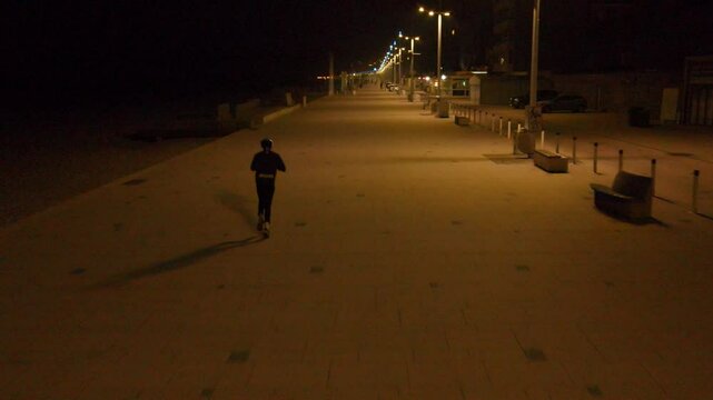 Jogger on the beach of Dunkerque, night time jogging