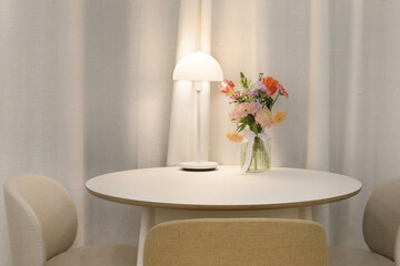 A small round table decorated with flowers and lights