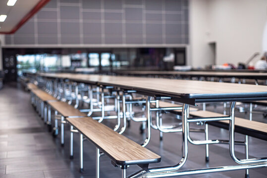 Empty rectangle mobile cafeteria table with bench seats for easy sit close or spread out at middle school in Dallas, Texas, laminate top resists scratches and stains, powder-coated steel frame