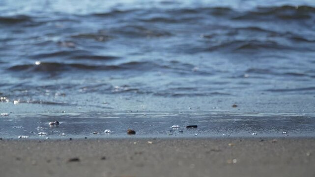 Close-up of waves on a sandy beach