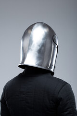 Closed Medieval Helmet with Slits. Polished silver helmet fully enclosing the head with vertical and horizontal viewing slits.