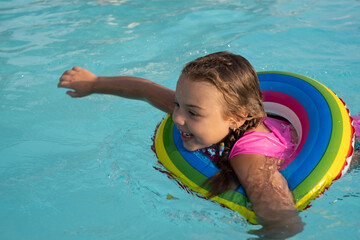 A 5-year-old girl is swimming in the pool