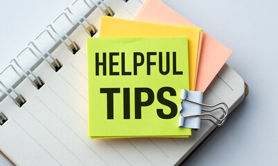 A yellow and orange sticky note with the word Helpful Tips written on it