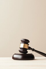 solitary gavel rests on wooden surface signifying legal authority and decision-making surrounded by ample sunlight