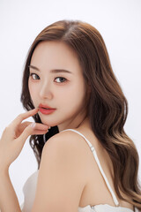 Fototapeta premium Beautiful young Asian woman model long hair with natural makeup on face clean fresh skin on isolated background. Cute girl portrait, Facial treatment, Body care, Beauty and Spa.