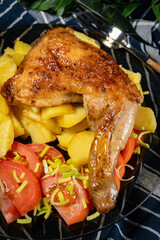 Appetizing baked chicken leg quarter.