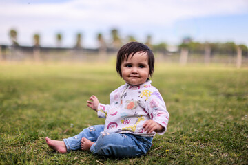 Little girl playing with bubbles in garden, nice day and funny