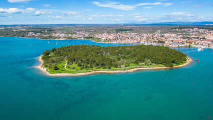 Aerial drone view of the beautiful Park šuma Kašteja (Kasteja), a lush green oasis on a peninsula near Medulin, Croatia. Surrounded by crystal-clear Adriatic waters