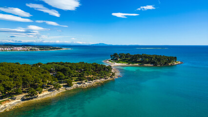 Aerial drone view of the beautiful Park šuma Kašteja (Kasteja), a lush green oasis on a peninsula near Medulin, Croatia. Surrounded by crystal-clear Adriatic waters