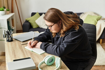 Young woman with Down syndrome enjoys writing in her cozy home workspace