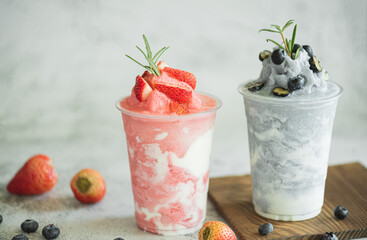 Closeup fresh strawberry milkshake, smoothie and topping on stone table background. Healthy food and summer drink concept