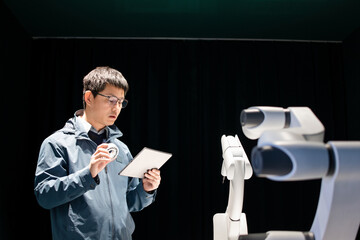 asian Robotics Engineer Researching and Developing a Technological Robot Arm Project