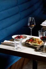 Dinner at the restaurant, chef's dishes and glasses of wine. Romantic dinner.