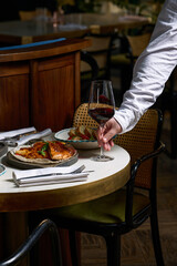 Dinner at the restaurant, chef's dishes and glasses of wine. Romantic dinner.