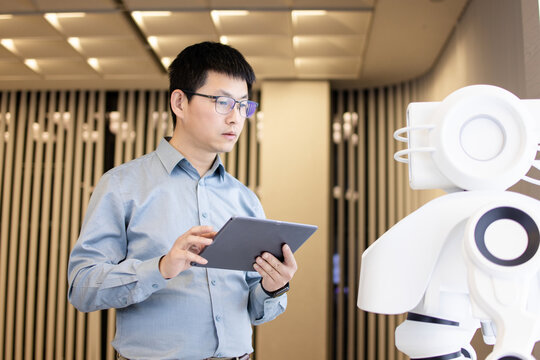 asian Robotics Engineer Researching and Developing a Technological Robot Arm Project