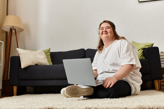 Young woman enjoys cozy moments at home while working on her laptop with confidence