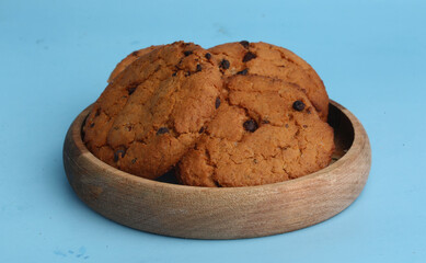 plate with chocolate cookies on blue background