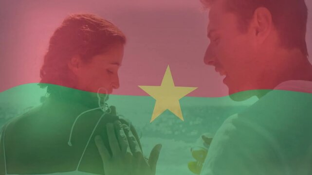 Listening to music, couple with Burkina Faso flag animation overlay