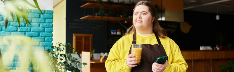 Confident young woman enjoying her time in a cozy cafe while holding a refreshing drink