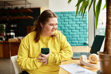 Confident young woman with Down syndrome enjoying time at cozy cafe with her smartphone
