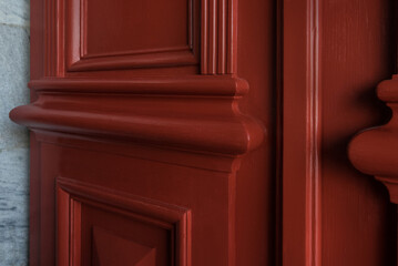 Close up of carved three-dimensional elements of the bevels of old entrance doors after restoration and painting